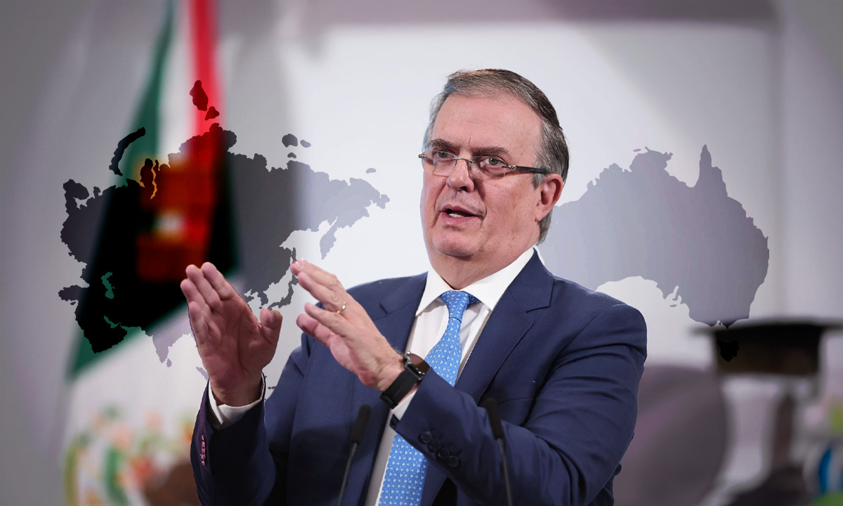 Marcelo Ebrard durante una intervención pública con un mapa mundial y la bandera de México al fondo