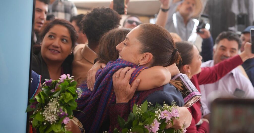 Abrazo entre asistentes durante un evento de apoyos en Zacatecas
