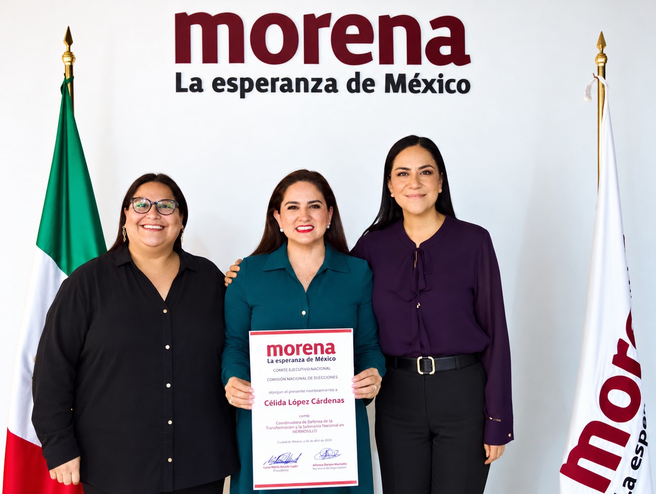 Tres mujeres posan ante emblemas de Morena; la mujer del centro sostiene un documento con el nombre de Célida López Cárdenas.